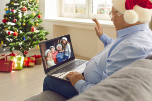 Man in a santa hat video chatting with family for Christmas