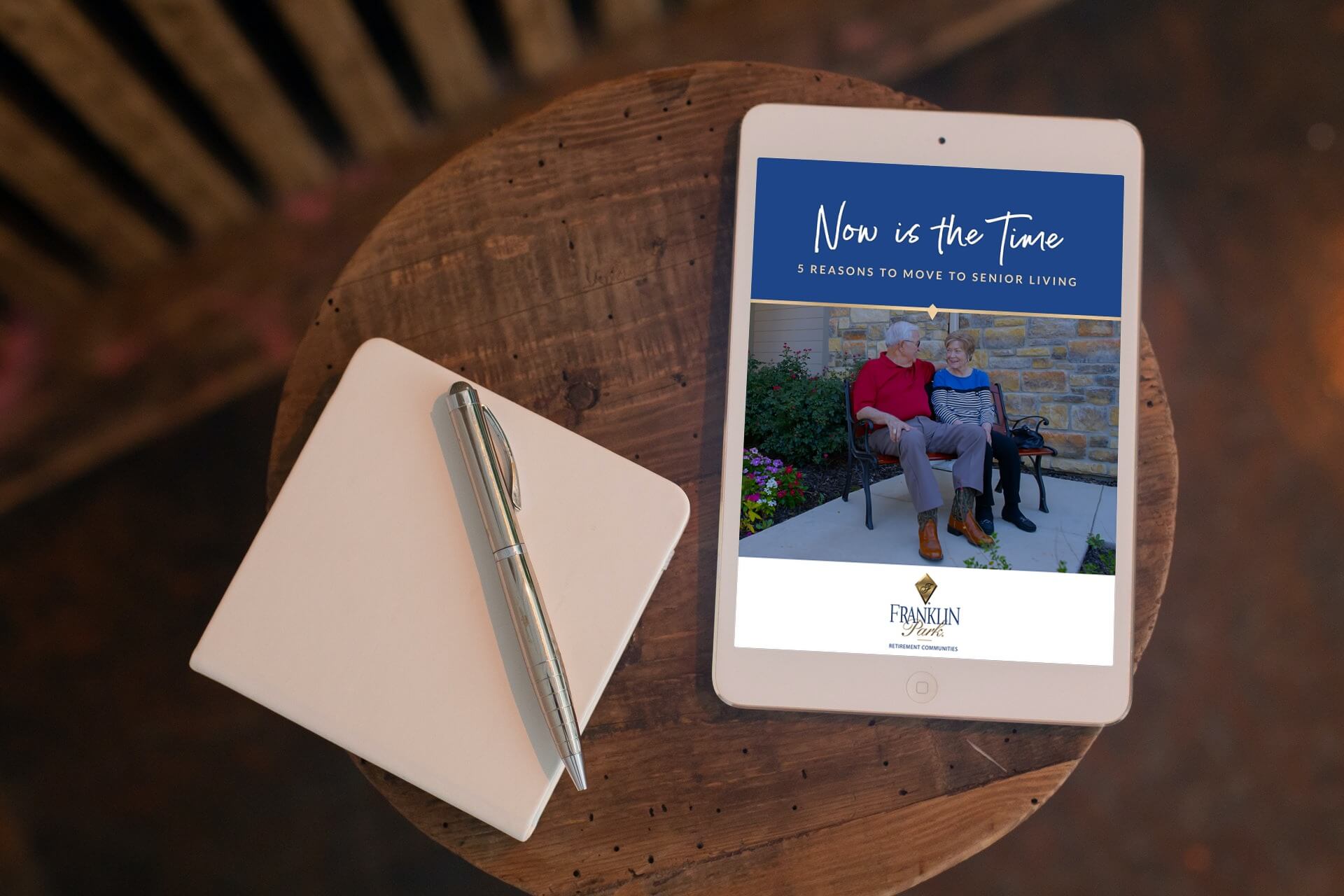 Tablet displaying senior living brochure on wooden table