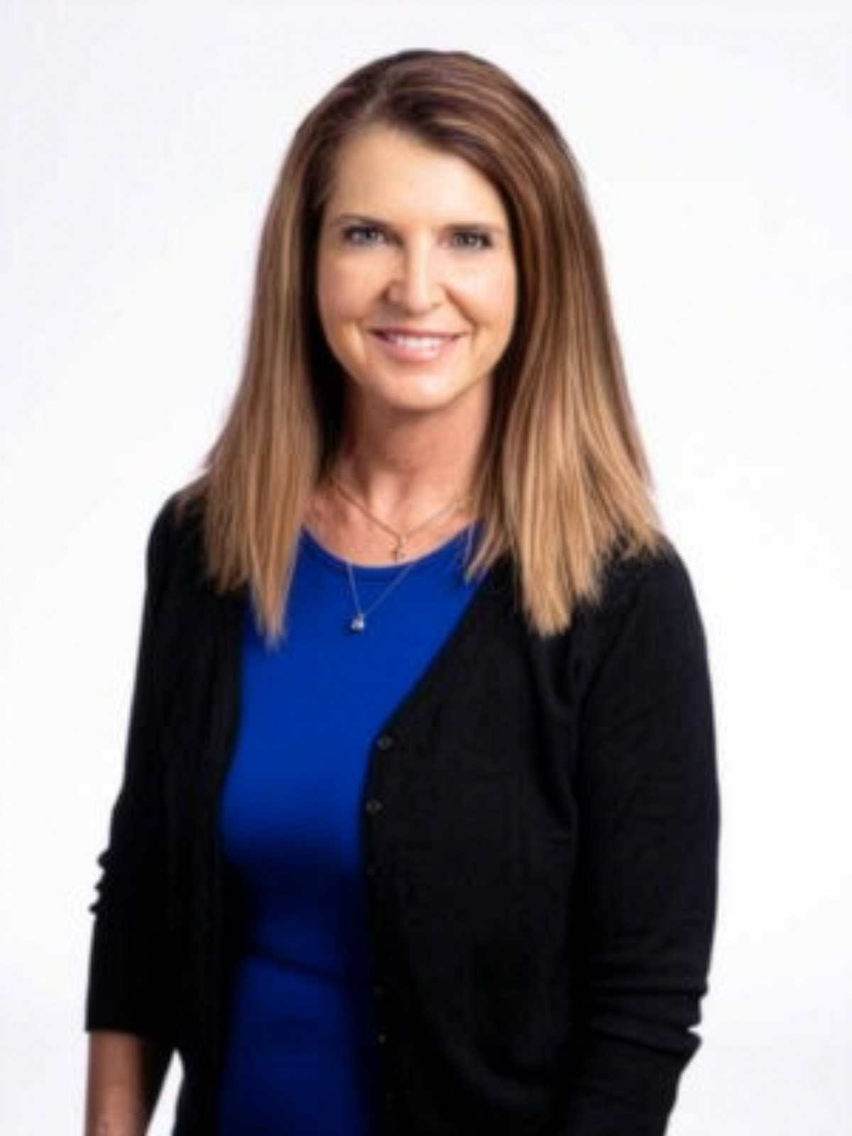 Professional headshot of smiling woman in blue top