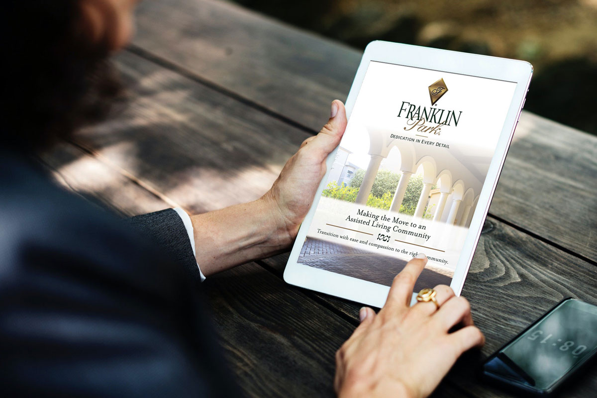 Person viewing assisted living brochure on tablet