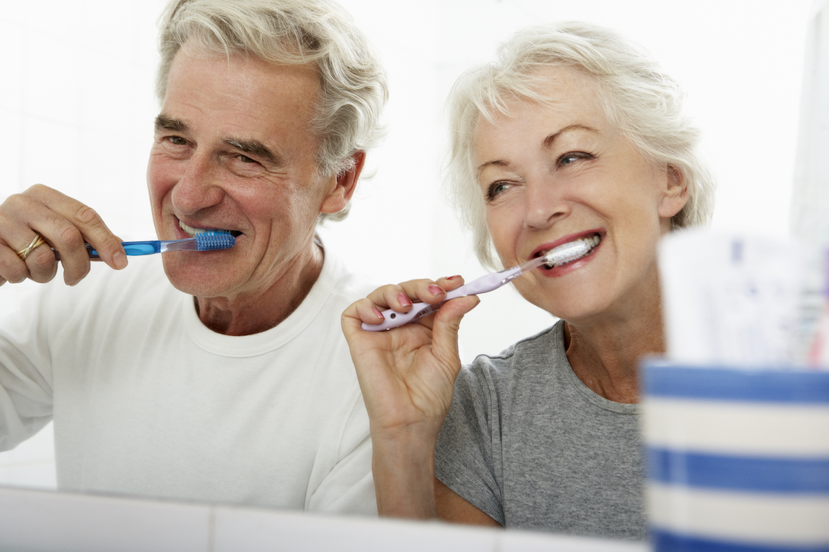 Senior,Couple,In,Bathroom,Brushing,Teeth