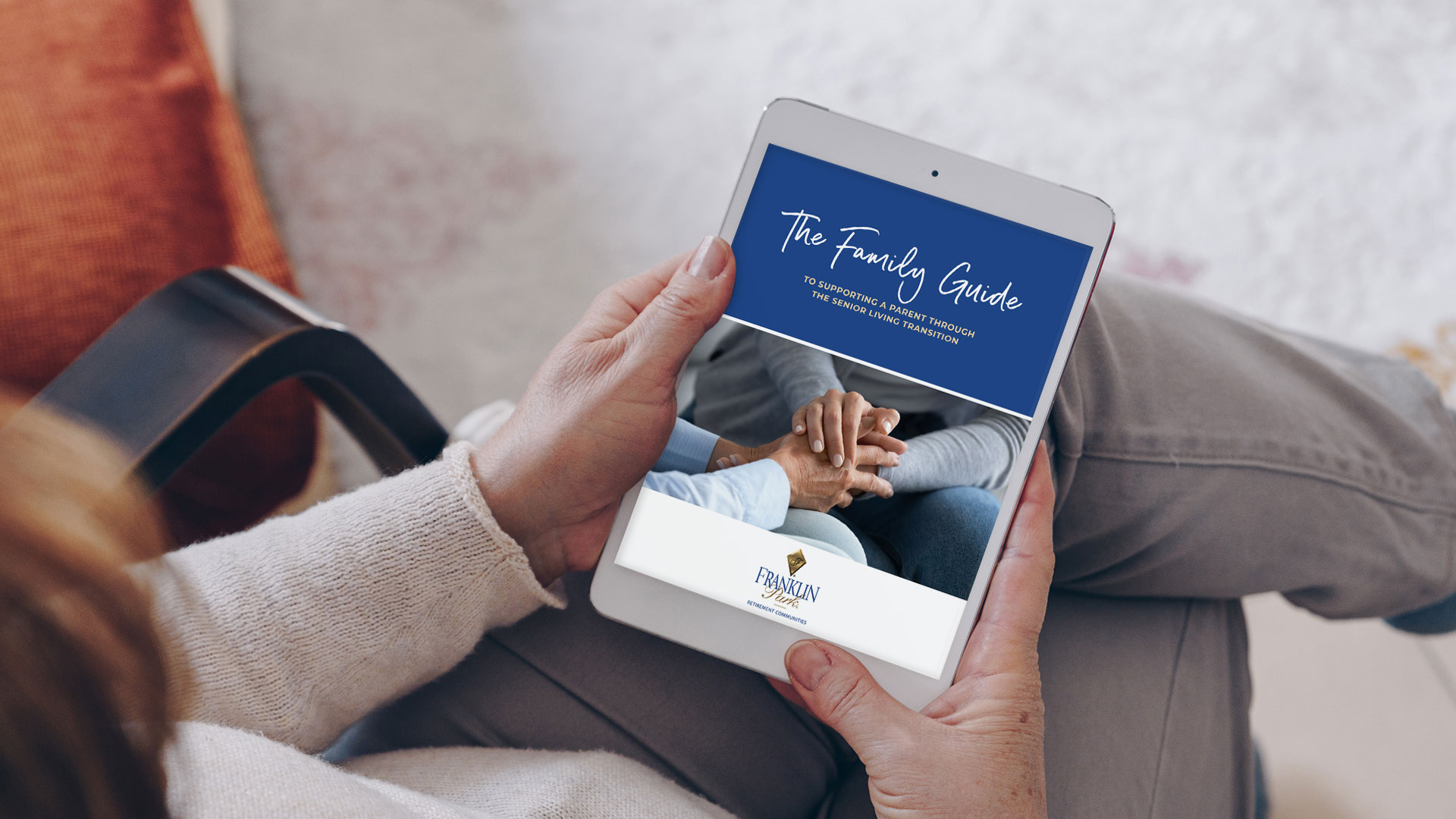 Person holding tablet with senior living family guide