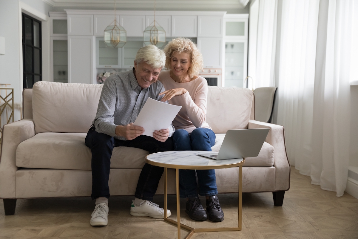 Attractive,Older,Couple,Reading,Received,Formal,Notification,,Smiling,Enjoy,News,