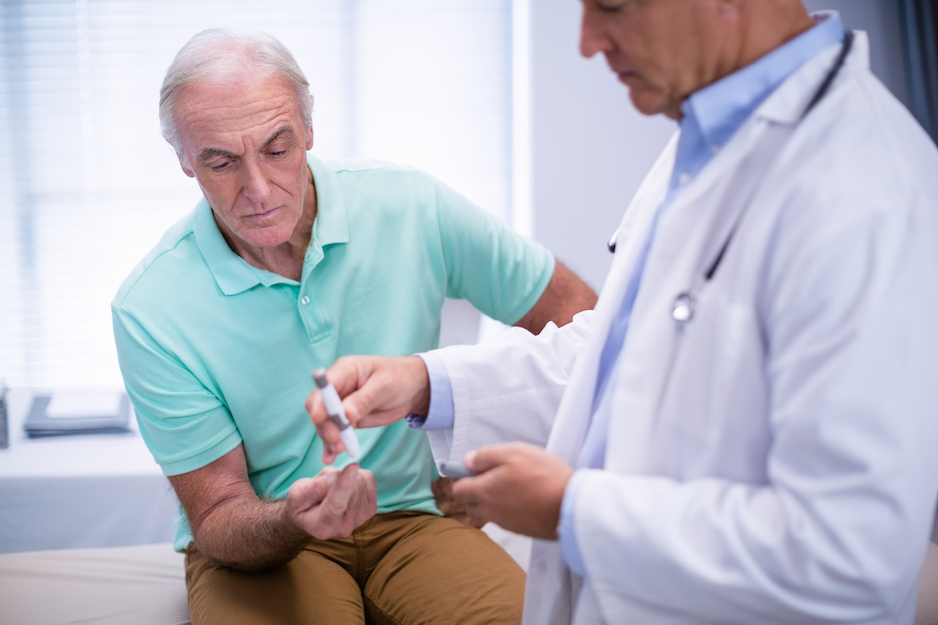 Doctor examining senior patient blood sugar