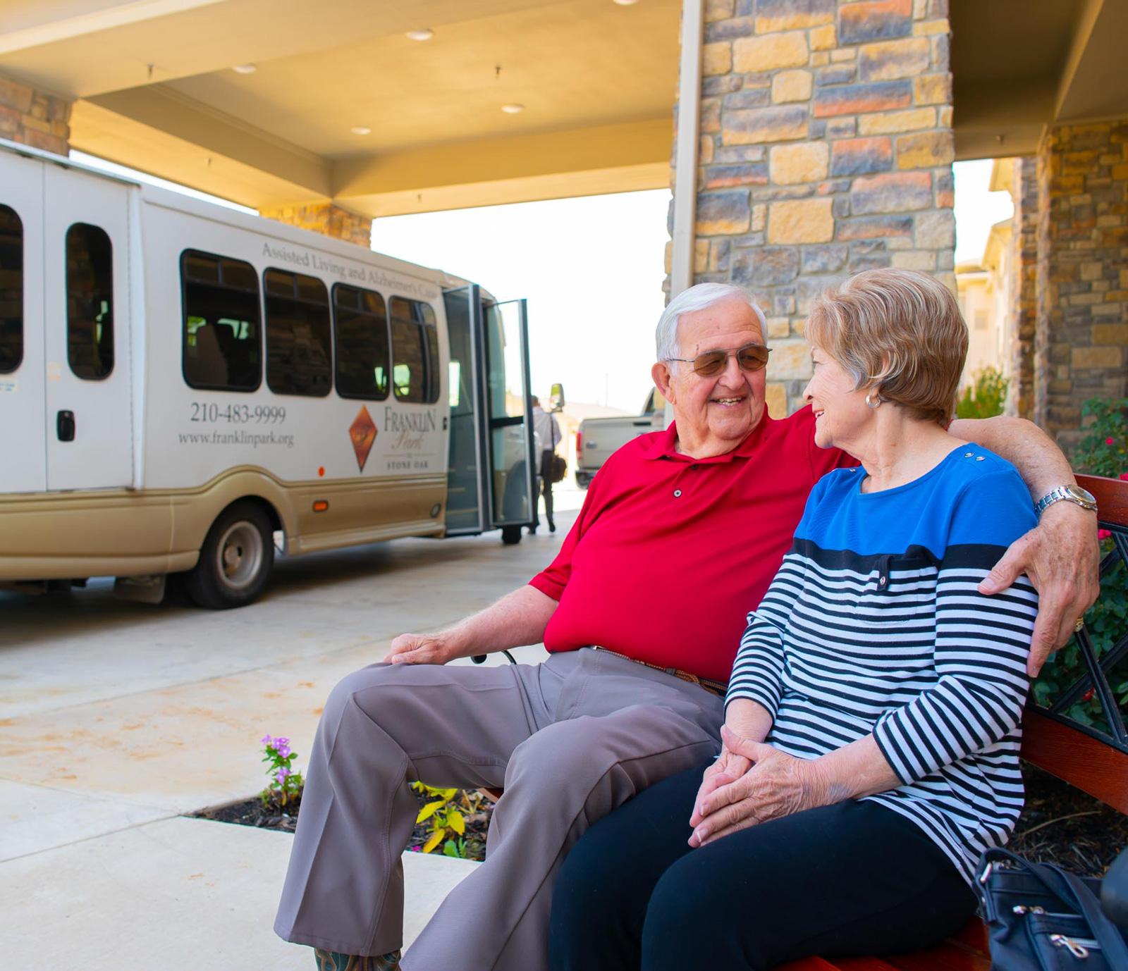 Senior couple sitting outside assisted living facility