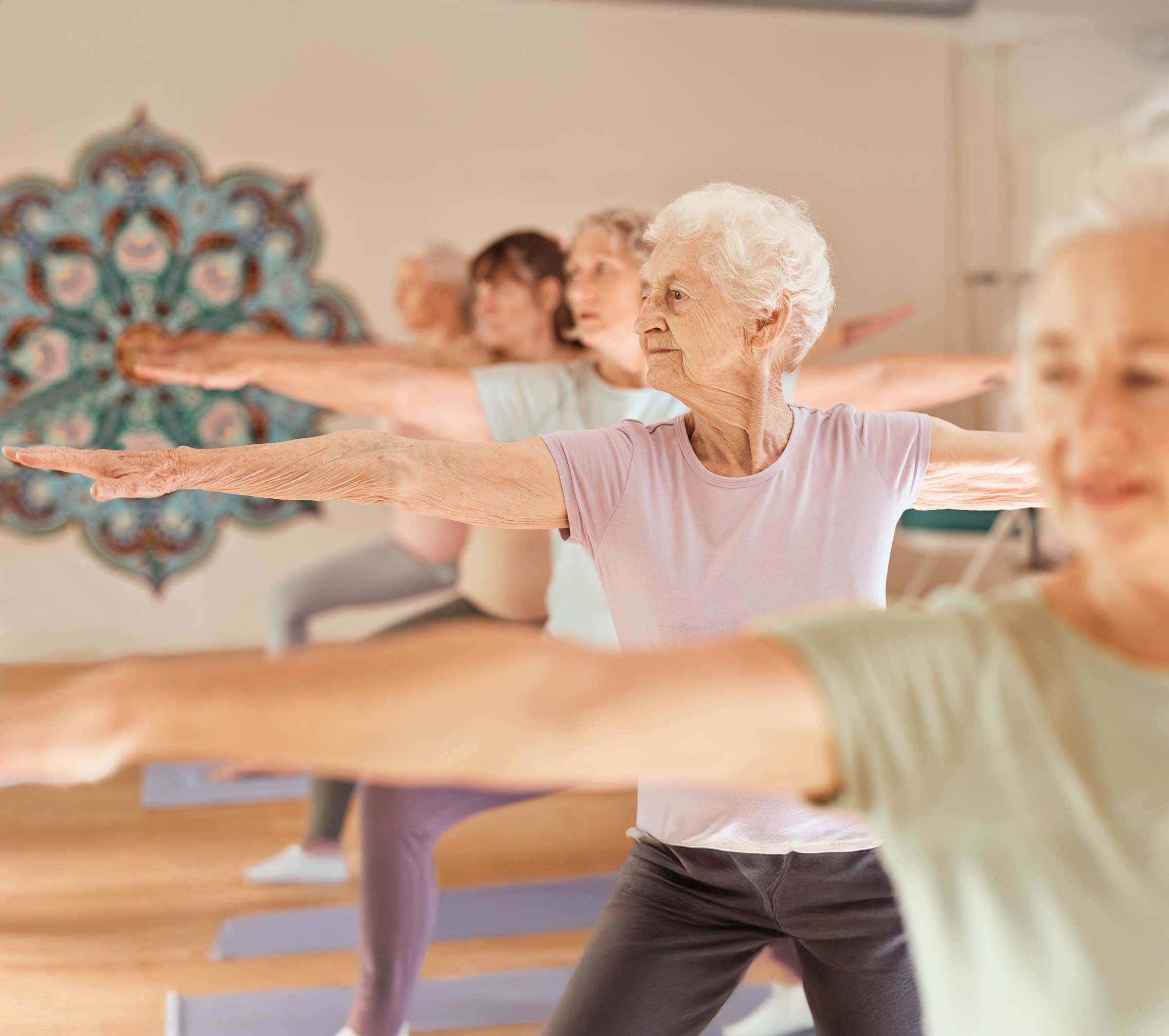 Senior women practicing yoga in a studio